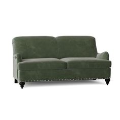 a green couch sitting on top of a white floor