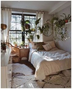 a bed room with a neatly made bed and lots of plants