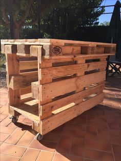 a wooden cart sitting on top of a brick floor