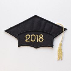 a black and gold graduation cap with the year 2018 embroidered on it's side