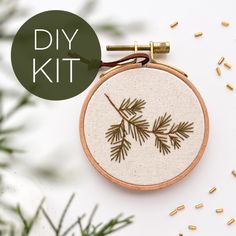 an embroidery kit with pine needles on it and the words diy kit above it