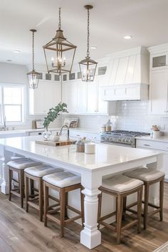 a large kitchen with white cabinets and an island