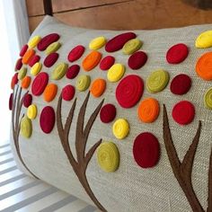 a decorative pillow with colorful circles on it