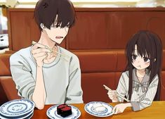 two people sitting at a table with plates and chopsticks in front of them