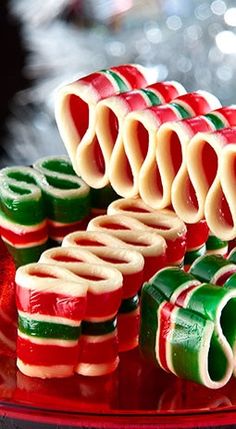 several pieces of candy are arranged on a red plate with green, white and red stripes