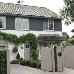 a house with ivy growing on it's walls and gate in front of it