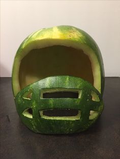 a helmet made out of watermelon sitting on top of a table