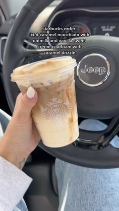 a person holding up a cup of coffee in their hand with the words jeep written on it