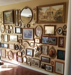 a wall covered in lots of framed pictures