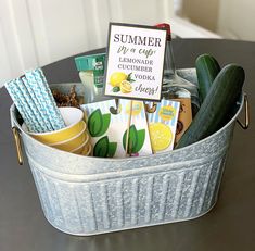 a metal tub filled with lots of different types of food and drinks on top of a table