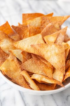 a white bowl filled with tortilla chips