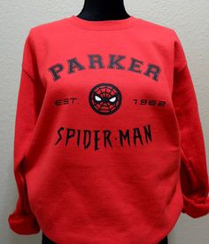 Parker/Spider-man Crew Neck Sweater Front: Lettering- Black vinyl Center- Black and White Vinyl Back: Spiders- Black vinyl Color may vary slightly from photo. True red 50% cotton 50% polyester Gildan Unisex Spiderman Sweater, Spiderman Merch, Spiderman Pictures, Ultimate Spiderman, Tucson Az, True Red, Moon Child, Black Vinyl, White Vinyl