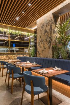 a restaurant with wooden tables and blue chairs