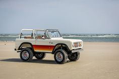 an off road vehicle parked on the beach