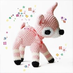 a crocheted pink and white stuffed animal with black eyes, nose and tail