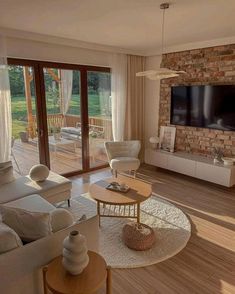 a living room filled with furniture and a flat screen tv mounted on the wall above a fireplace