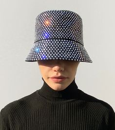 Ruslan Baginskiy Crystal-embellished Bucket Hat’s name says it all. It is a bucket hat, embellished with almost a bucket of crystals. Everyone may be dazzled by your glow, but the delicate brim of this limited-edition piece will protect your eyes from sun and party lights.
While wearing a hat is no more required in the XXI century, having fun is forever required! Having fun is essential, we would say. And you always get more fun with a proper accessory. Let’s dress up to the nines. Let’s dress up nine-to-five, twenty-four seven. Let’s be ironic enough to make glamour a part of our casual wardrobe. Accessories Online Shop, Plain Outfits, Twenty Four, Hats Accessories, Wearing A Hat, Party Lights, The Nines, Having Fun, Casual Wardrobe