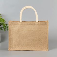 a jute bag sitting next to a potted plant