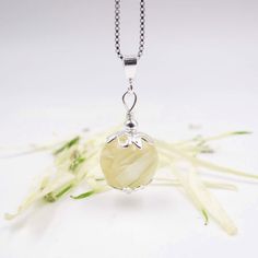 This pendant features a bead handcrafted with flower petals and resin and is complemented with sterling silver floral hugging caps and bead to complete this design. ◄Size Bead Dimension: 12mm ◄Color The look and color of the flowers preserved in resin will depend on the condition of the flowers when they are received. We dry the flowers soon as they arrive. However, flowers may change colors as they dry. i.e., white flowers may dry cream or darker portraying a vintage look. Some flowers fall apa Sterling Silver Flower Keepsake Jewelry, Sterling Silver Flower Jewelry Keepsake, Sterling Silver Flower Jewelry For Keepsake, Silver Resin Flower Jewelry, Silver Flower Shaped Resin Jewelry, Handmade Sterling Silver Flower Necklace, Elegant Resin Jewelry With Flower Charm, Elegant Resin Jewelry With Birth Flower Detail, Elegant Resin Birth Flower Jewelry