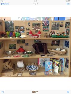 a book shelf filled with lots of books and other items on top of wooden shelves