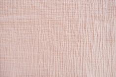 the texture of an old pink linen material