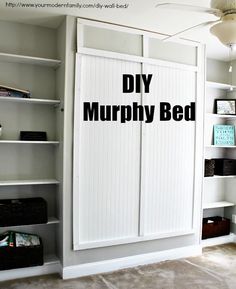 a bedroom with white bookcases and an open door that says diy murphy bed