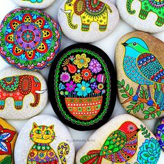 painted rocks with different designs and animals on them