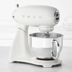 a white mixer sitting on top of a counter