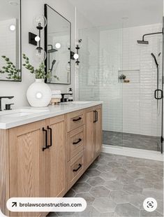 a bathroom with two sinks and mirrors on the wall