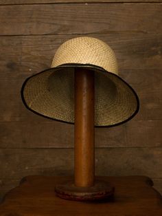 "An authentic antique woven cloche from the late 1920s or 30s era. Originally acquired by a European hat shop that closed in the 1930s. Made from a light colored woven straw with a simple yet elegant black wax coated ribbon and buckle. Only minor signs of age from storage, never been previously used. Centimeter measurements written on the inside of the crown by the hat maker. material : straw, silk? ribbon color : black, light beige condition : little to no wear, has never been used size : pleas Adjustable Wide Brim Flapper Hat, Victorian Adjustable Cloche Hat, Adjustable Cloche Hat For Vintage Events, Vintage Cloche Hat With Curved Brim For Vintage Fashion, Vintage Hat With Curved Brim And Lining, Vintage Wide Brim Lined Hat, Adjustable Curved Brim Hat For Vintage Fashion, Vintage Natural Color Adjustable Hats, Adjustable Vintage Natural Hat Band