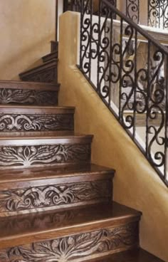 the stairs are made of wood and wrought iron