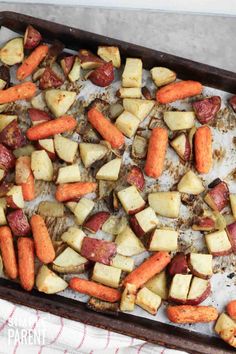 roasted potatoes and carrots on a baking sheet