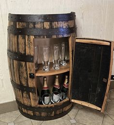 a wooden barrel with wine glasses in it