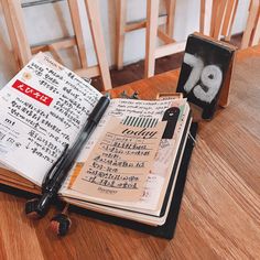 an open notebook sitting on top of a wooden table