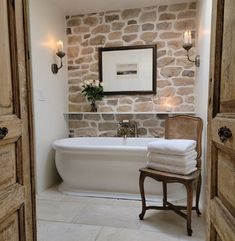 a white bath tub sitting next to a wooden door