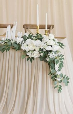 a table with flowers and candles on it