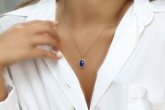 Effortlessly chic and intricate, this blue stone necklace gorgeously showcases a Lapis Lazuli stone, oval-cut and held in a delicately detailed setting. Lapis Lazuli is a September birthstone and will be a lovely touch of sophistication for everyday and special occasions. A stylish and vibrant jewelry piece for you or for a gift Finish is customizable to other materials Can be purchased in different necklace lengths Nickel Free and Tarnish Resistant Thoughtfully packaged with a fancy gift kit Pr Elegant Oval Cabochon Pendant Necklace, Elegant Blue Cabochon Necklaces, Elegant Blue Cabochon Necklace, Elegant Blue Oval Cabochon Necklace, Elegant Oval Cabochon Birthstone Jewelry, Elegant 14k Gold Oval Cabochon Necklace, Elegant Sapphire Jewelry With Cabochon, Elegant Birthstone Jewelry In Oval Cabochon, Elegant Blue Cabochon Jewelry