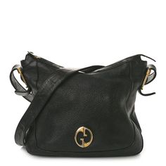 This is an authentic GUCCI Leather 1973 Messenger in Black.  This chic messenger bag is crafted beautifully of fine leather and features a looping leather shoulder strap and polished brass hardware interlocking GG logo on the front. It opens with a top zipper to  a suede interior with zipper and patch pockets.  This is a delightful bag that will be ideal for day or evening, from Gucci! Gg Logo, Gucci Leather, Brass Hardware, Polished Brass, Patch Pocket, Messenger Bag, Shoulder Strap, Gucci, Brass