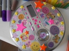 a cd player sitting on top of a table with lots of stickers around it