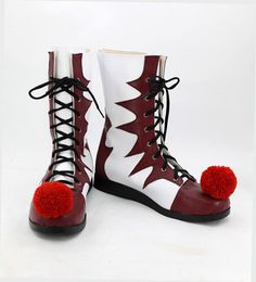 a pair of red and white boots with pom - poms