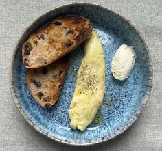 a blue plate topped with two pieces of bread and an egg