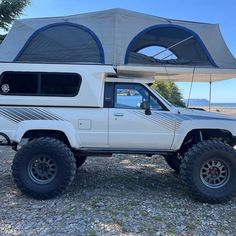 a white truck with a tent on the roof