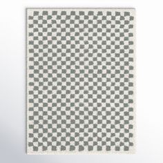 a gray and white checkered rug on a wall