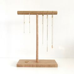 a wooden stand with several pairs of earrings hanging from it