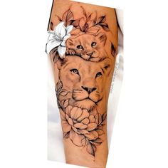 a woman's arm with a lion and flower tattoo on it