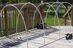 a metal bed frame sitting on top of a wooden deck