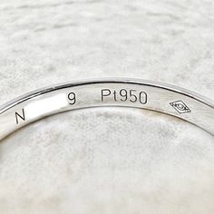 a close up of a silver bracelet on a white surface