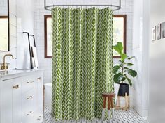 a bathroom with a green shower curtain next to a sink