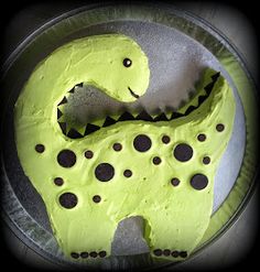 a cake shaped like a dinosaur with holes in it