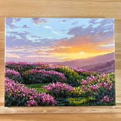 a painting of pink flowers on a wooden shelf